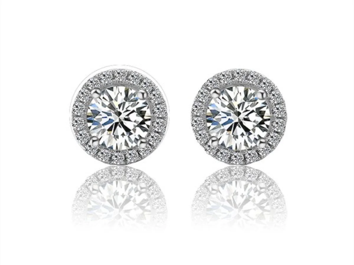 Halo diamond earrings matched to a bridal line, manufactured by Vesta Jewelry